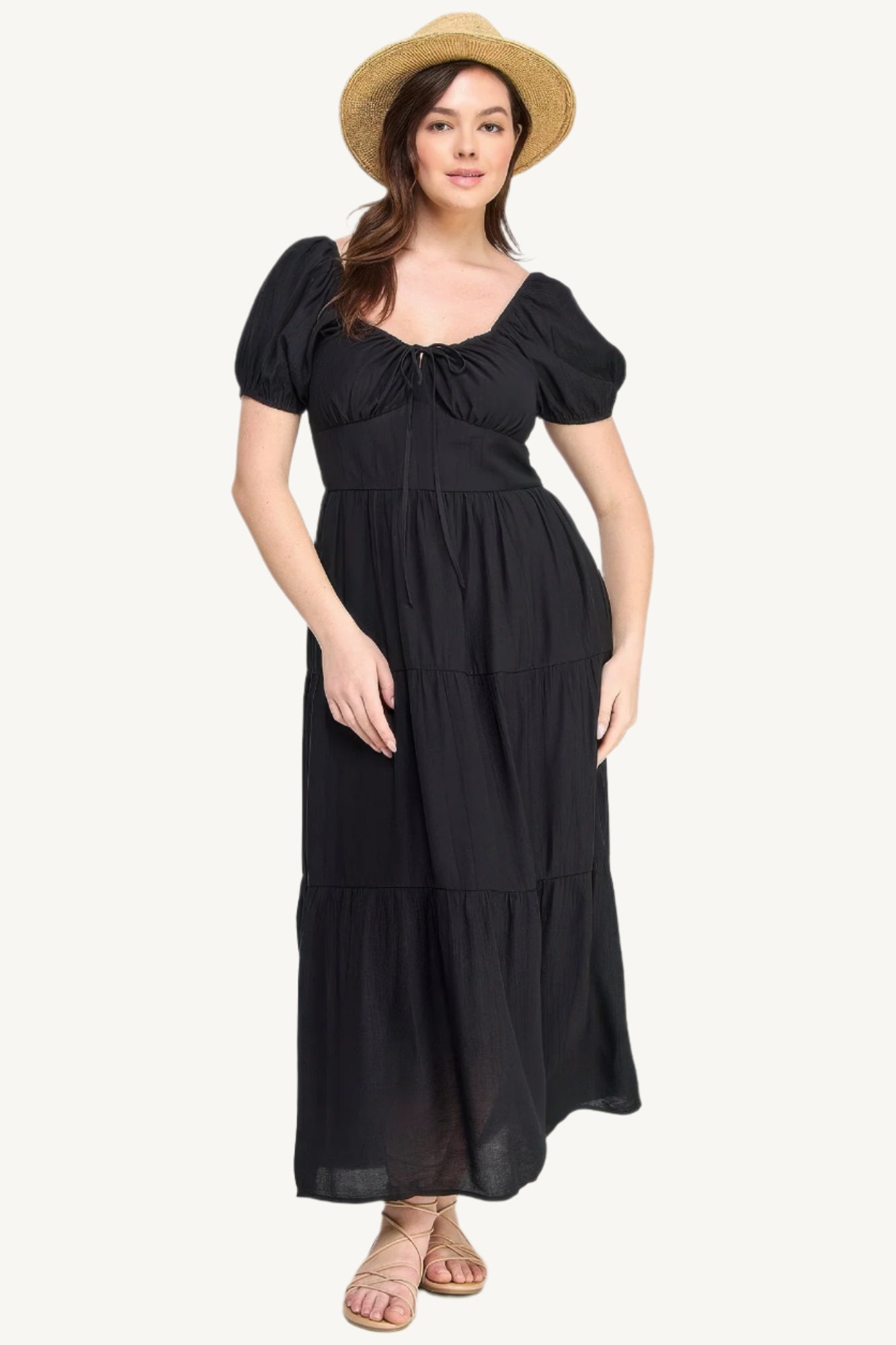 Plus-size black tiered maxi dress with front tie, puff sleeves, and flowing silhouette. Lightweight polyester fabric for breathable, elegant comfort and style.