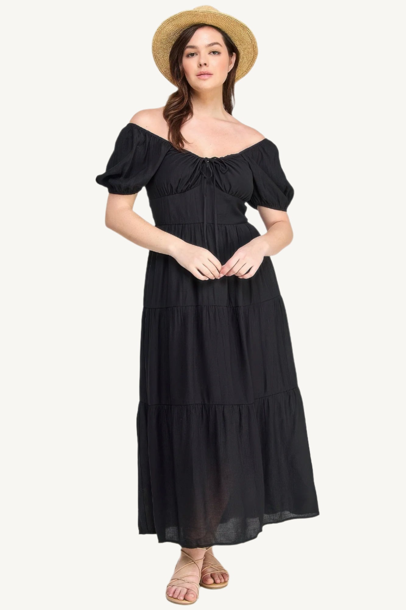 Plus-size black tiered maxi dress with front tie, puff sleeves, and flowing silhouette. Lightweight polyester fabric for breathable, elegant comfort and style.
