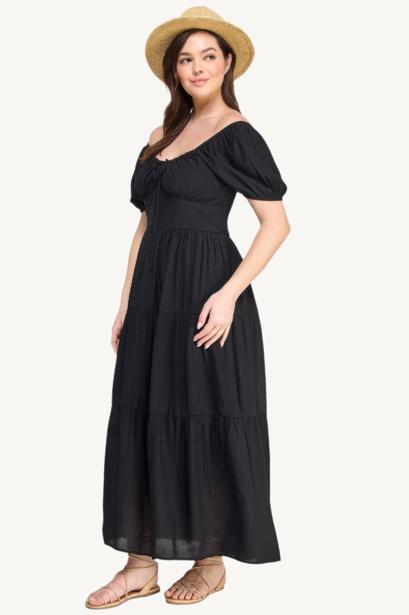 Plus-size black tiered maxi dress with front tie, puff sleeves, and flowing silhouette. Lightweight polyester fabric for breathable, elegant comfort and style.
