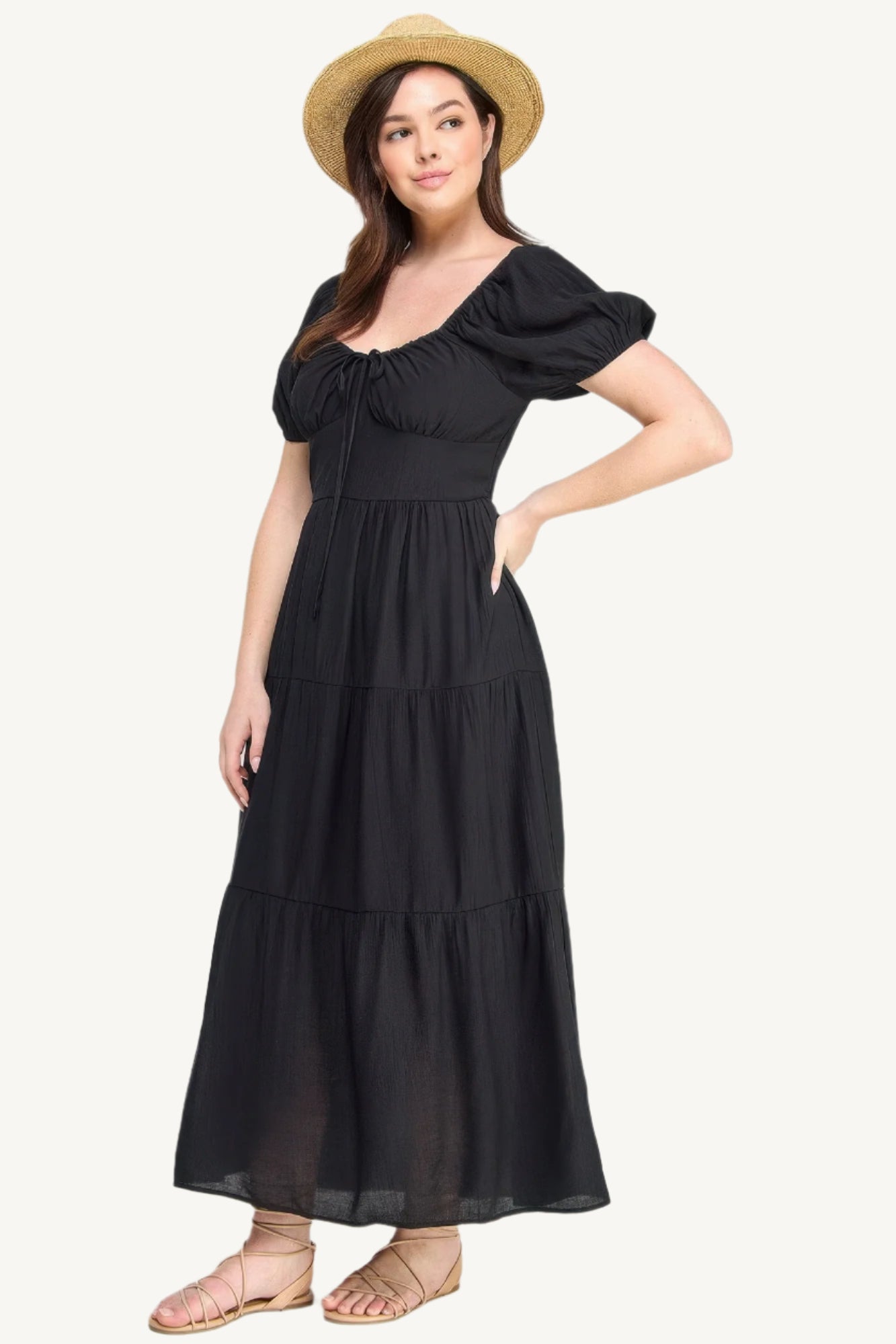 Plus-size black tiered maxi dress with front tie, puff sleeves, and flowing silhouette. Lightweight polyester fabric for breathable, elegant comfort and style.