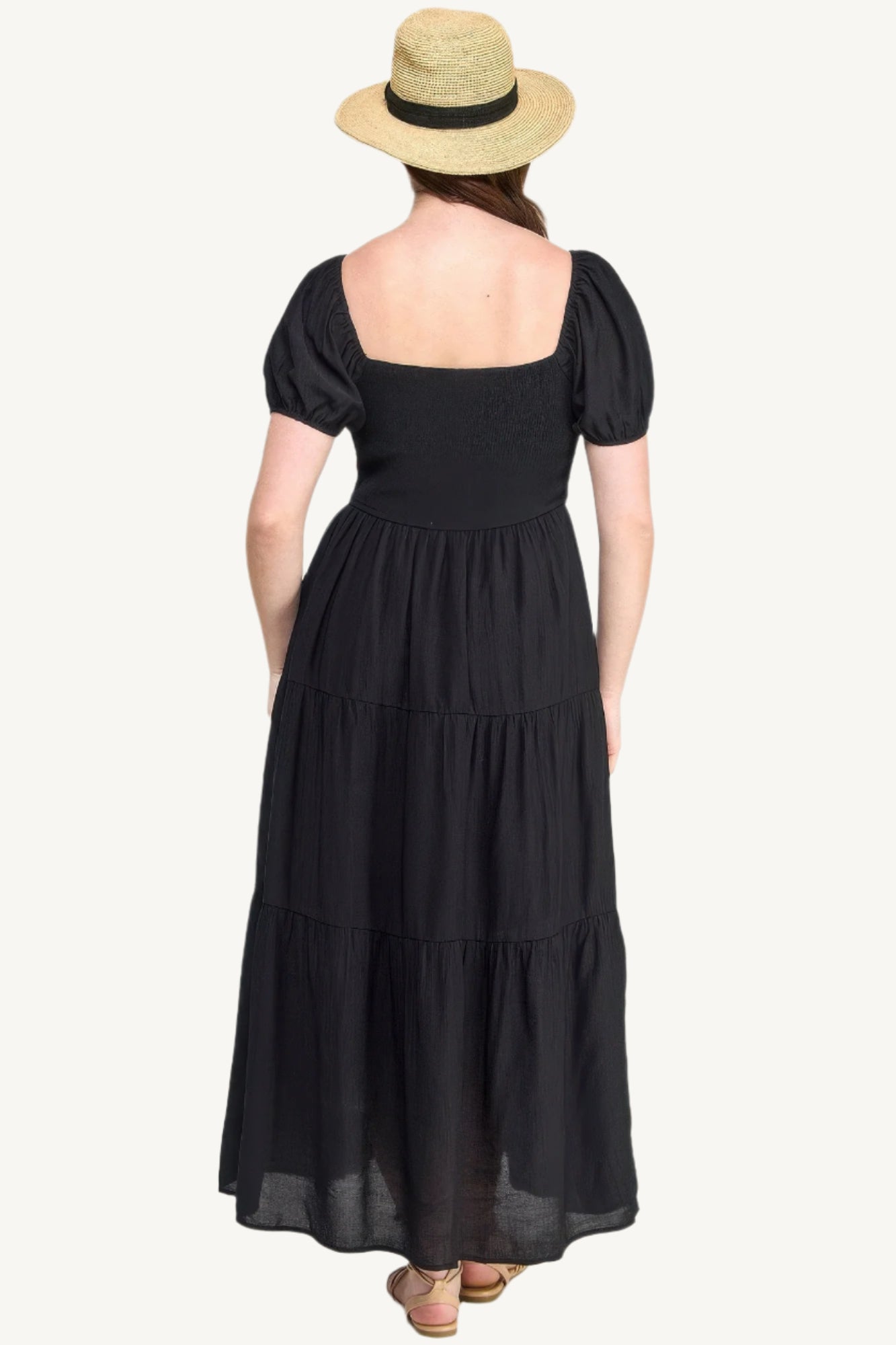 Plus-size black tiered maxi dress with front tie, puff sleeves, and flowing silhouette. Lightweight polyester fabric for breathable, elegant comfort and style.
