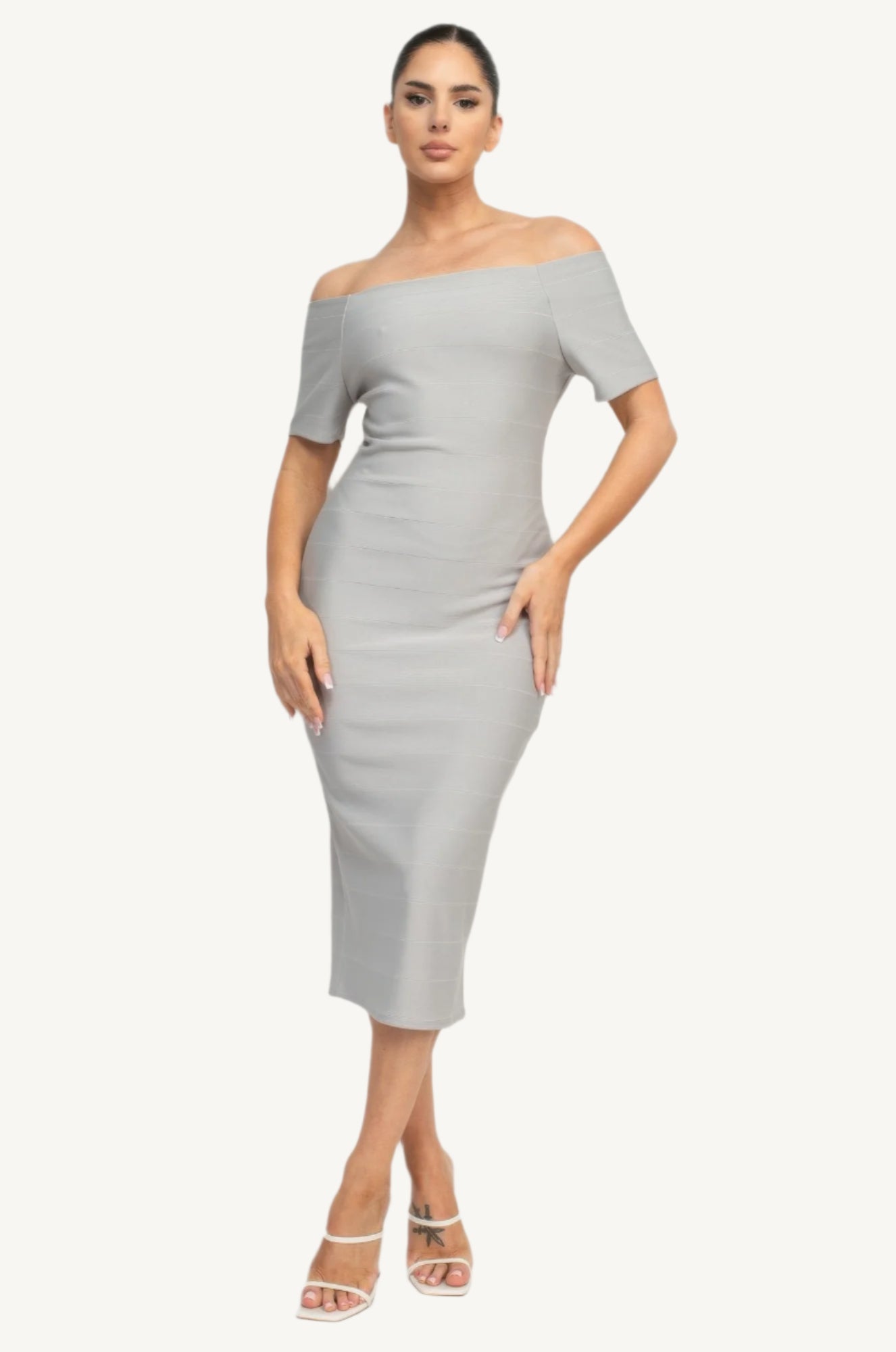 Off-shoulder bodycon dress with short sleeves, back zipper, and knee-length slit – made from soft stretch knit for a flattering, elegant fit.