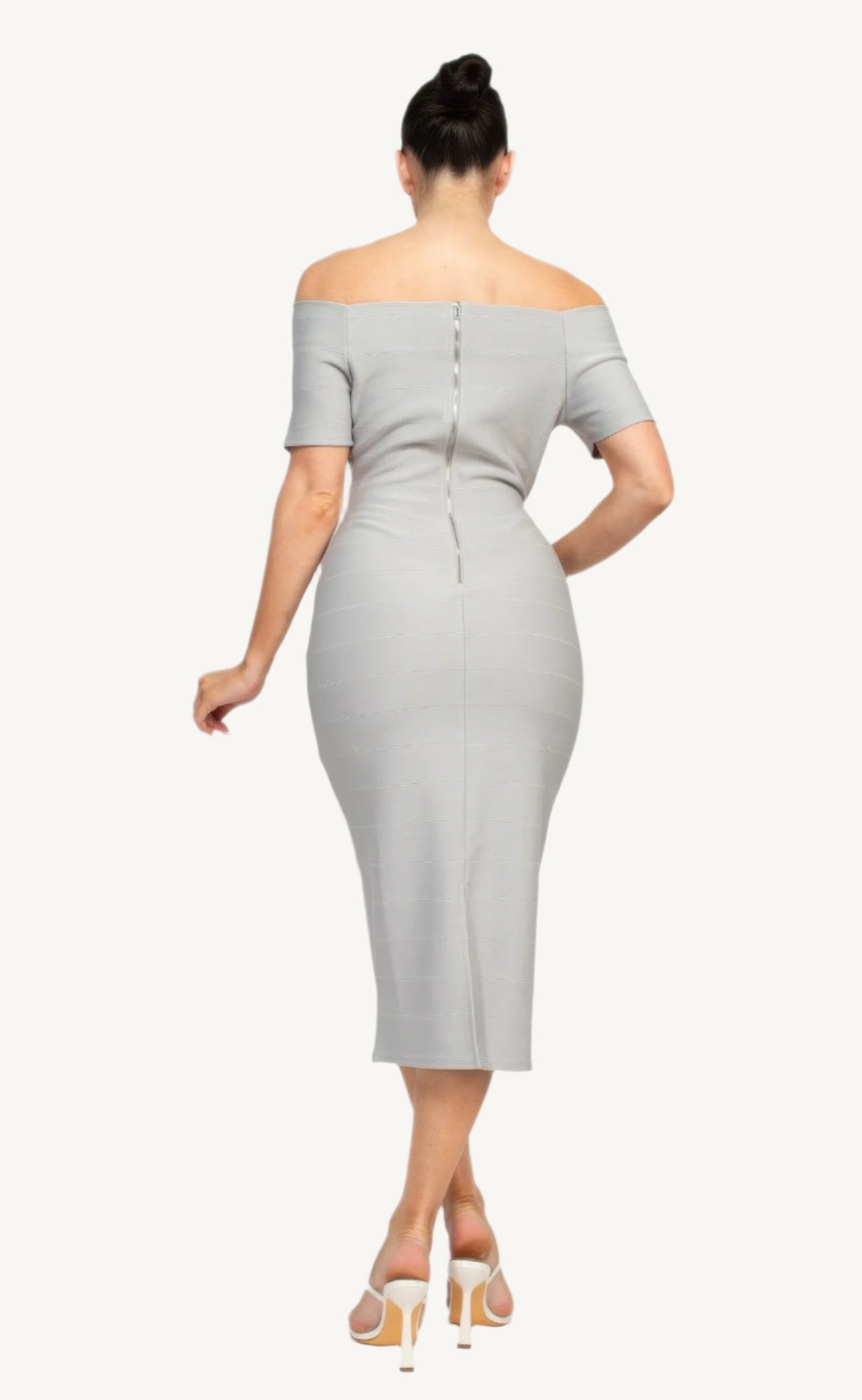Off-shoulder bodycon dress with short sleeves, back zipper, and knee-length slit – made from soft stretch knit for a flattering, elegant fit.