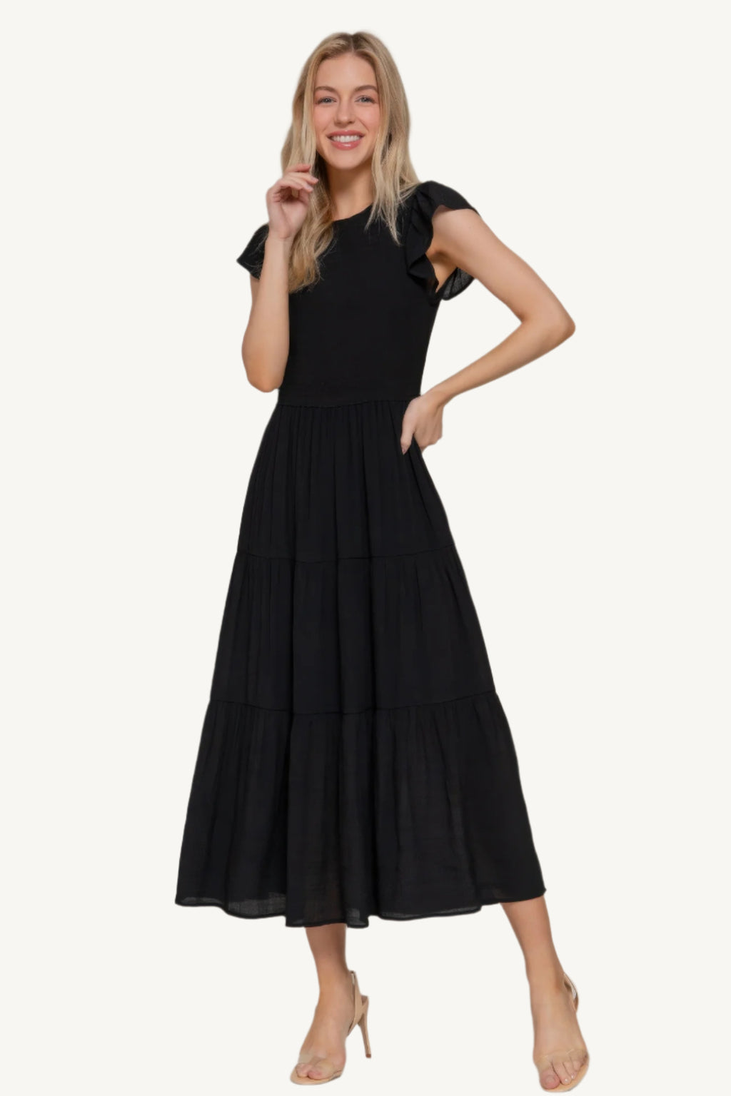 Solid tiered dress with ruffle sleeves, smocked bodice, and crew neckline – lightweight rayon-polyester blend for a romantic and flattering everyday fit.