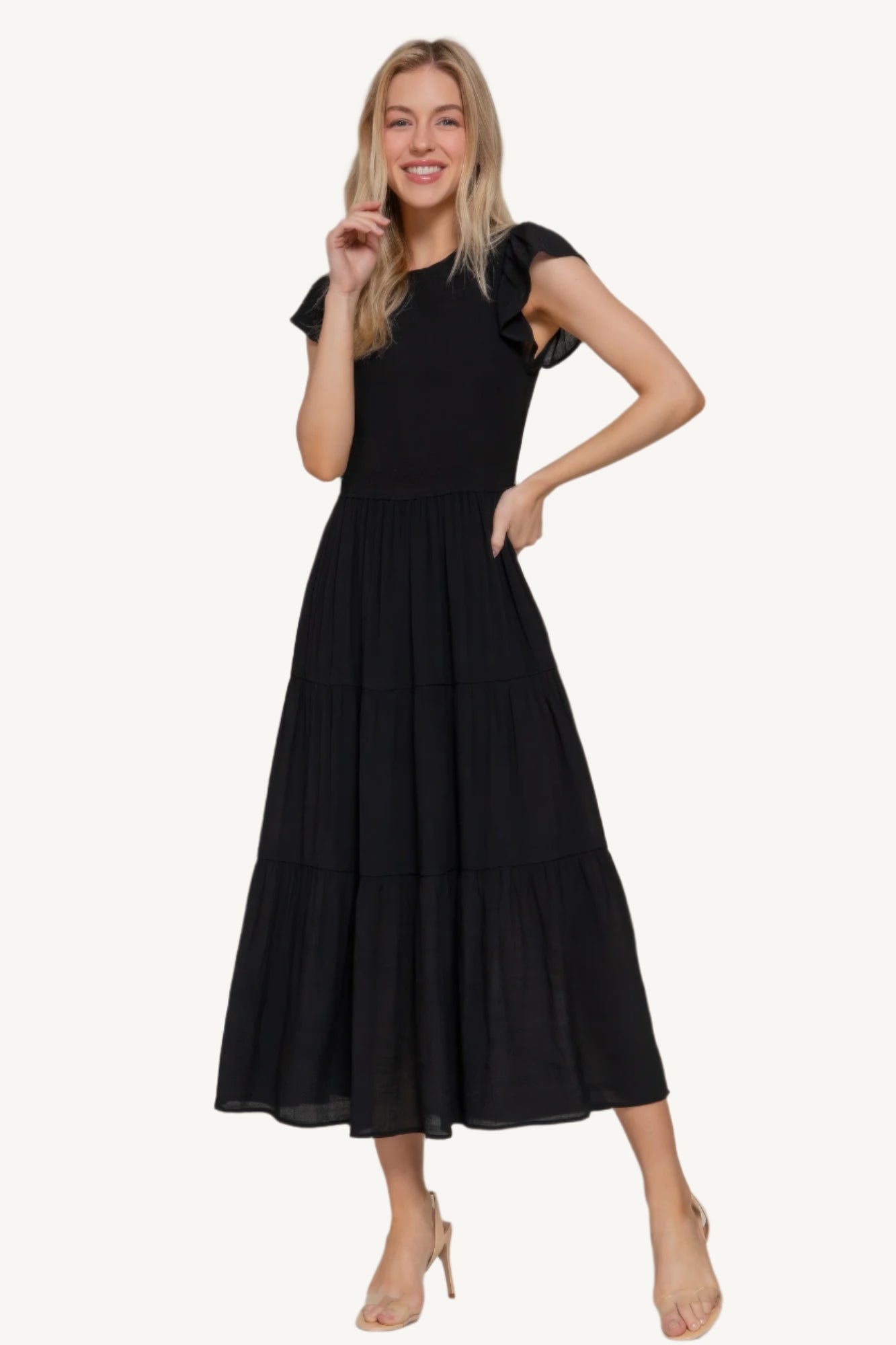 Solid tiered dress with ruffle sleeves, smocked bodice, and crew neckline – lightweight rayon-polyester blend for a romantic and flattering everyday fit.