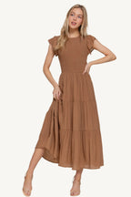 Ruffle sleeve tiered dress with smocked bodice and crew neckline, made from a lightweight rayon-polyester blend – romantic, flattering, and perfect for everyday wear.