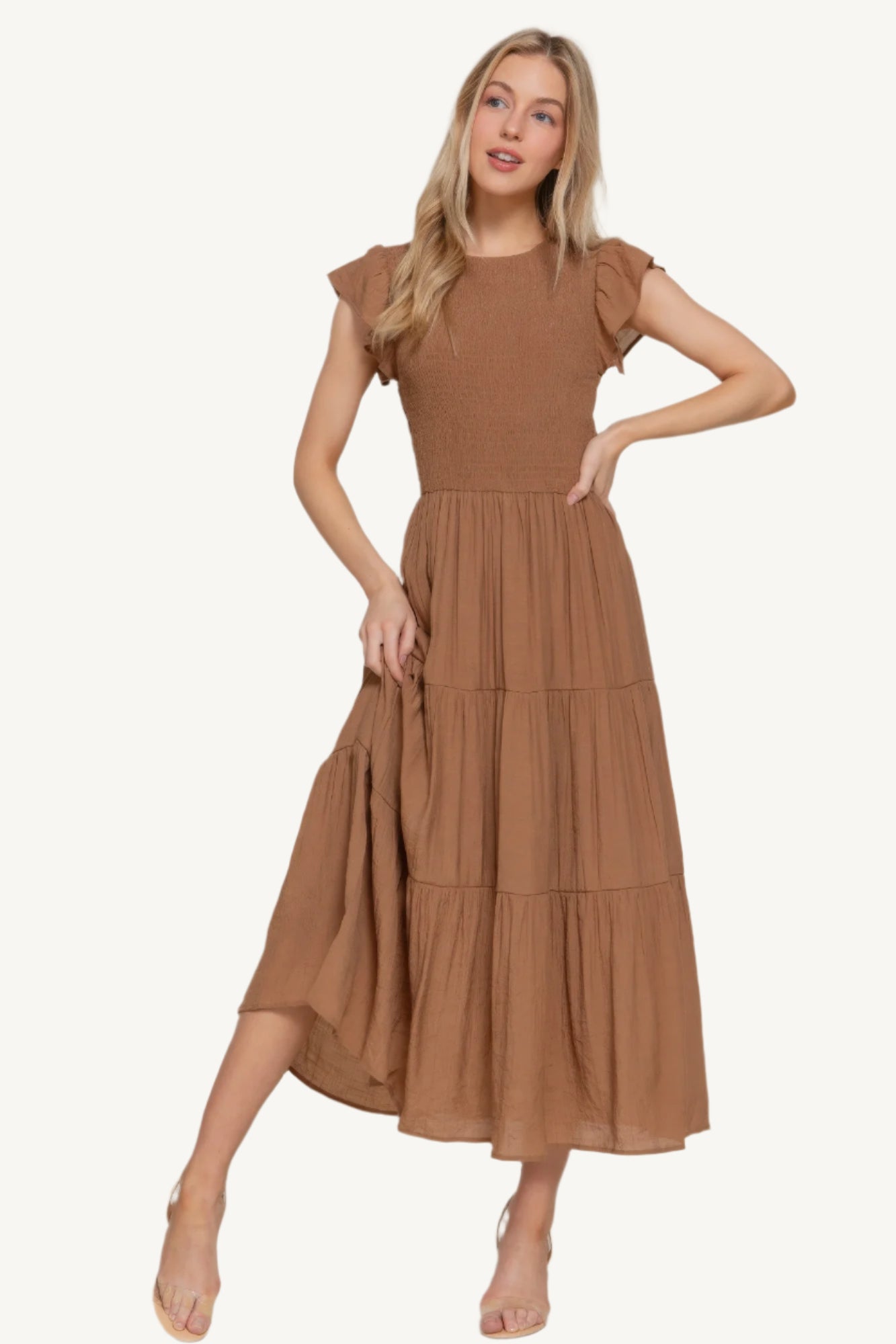 Ruffle sleeve tiered dress with smocked bodice and crew neckline, made from a lightweight rayon-polyester blend – romantic, flattering, and perfect for everyday wear.