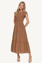 Ruffle sleeve tiered dress with smocked bodice and crew neckline, made from a lightweight rayon-polyester blend – romantic, flattering, and perfect for everyday wear.