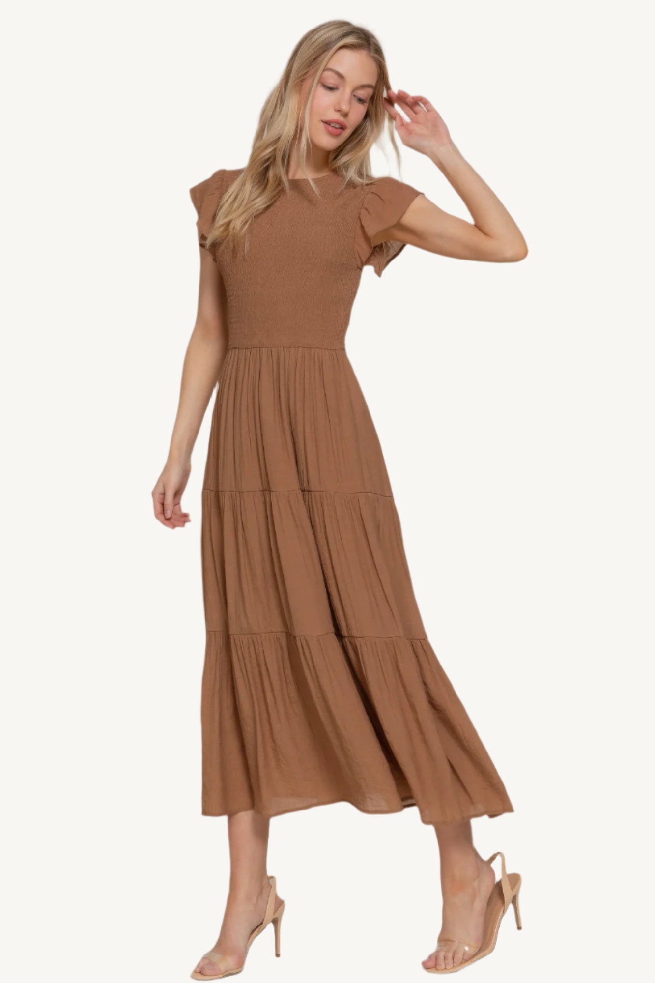 Ruffle sleeve tiered dress with smocked bodice and crew neckline, made from a lightweight rayon-polyester blend – romantic, flattering, and perfect for everyday wear.