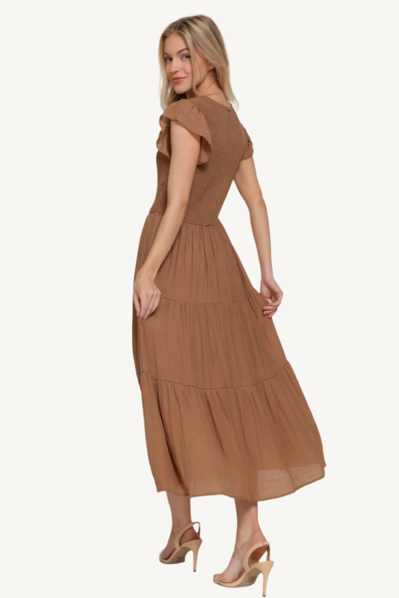 Ruffle sleeve tiered dress with smocked bodice and crew neckline, made from a lightweight rayon-polyester blend – romantic, flattering, and perfect for everyday wear.
