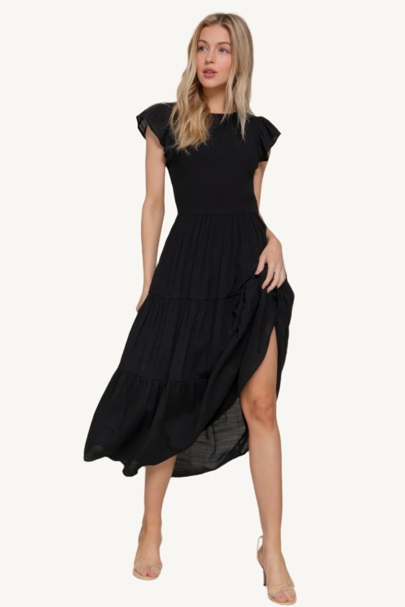 Solid tiered dress with ruffle sleeves, smocked bodice, and crew neckline – lightweight rayon-polyester blend for a romantic and flattering everyday fit.