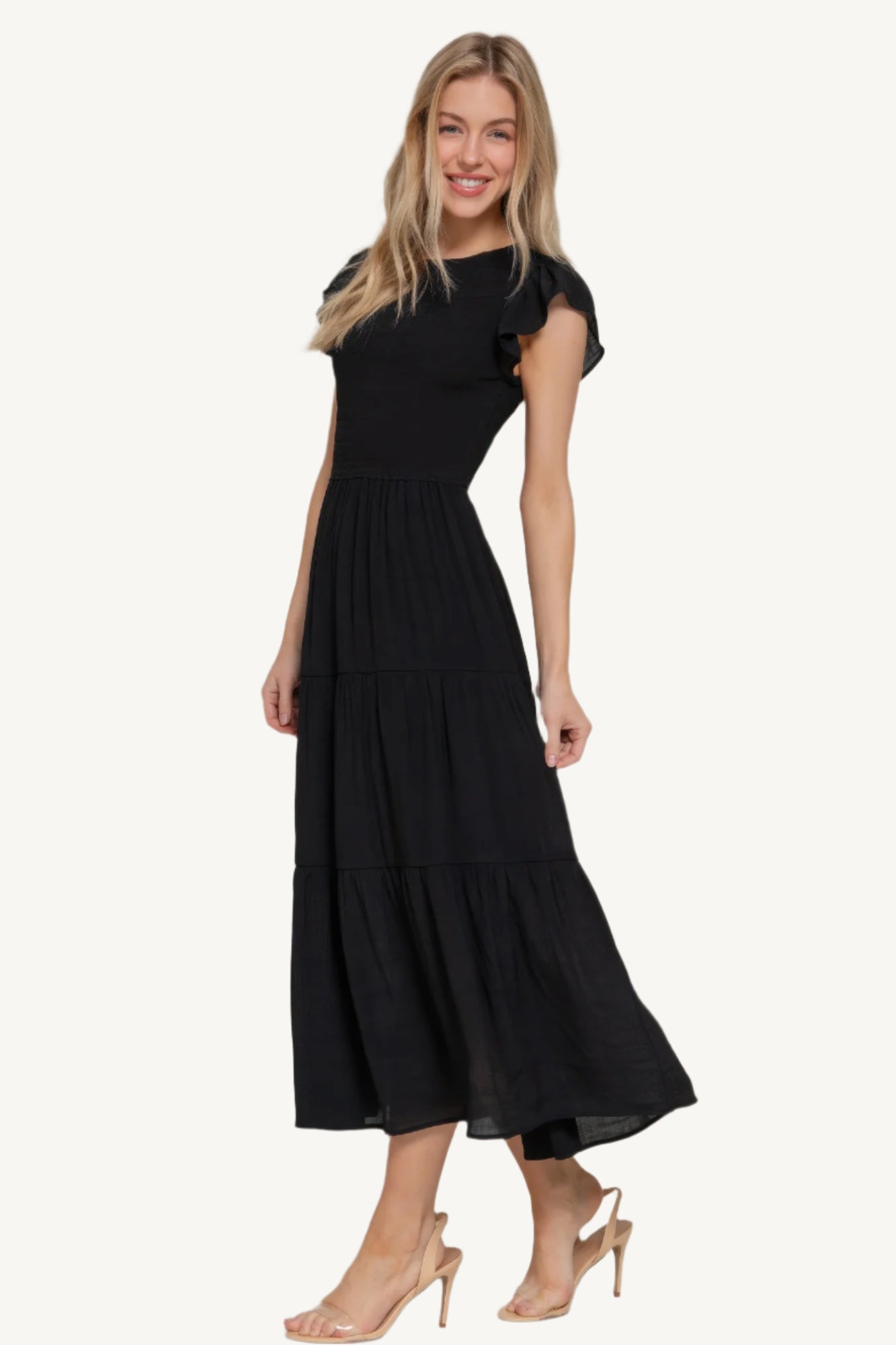 Solid tiered dress with ruffle sleeves, smocked bodice, and crew neckline – lightweight rayon-polyester blend for a romantic and flattering everyday fit.