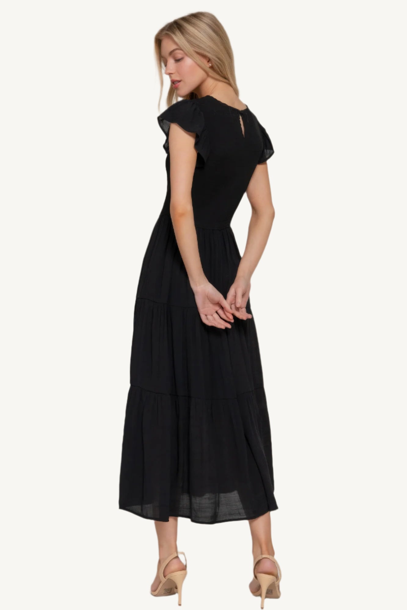 Solid tiered dress with ruffle sleeves, smocked bodice, and crew neckline – lightweight rayon-polyester blend for a romantic and flattering everyday fit.