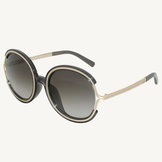 "Chloé women's sunglasses, model CE711SA-036, featuring clear dark gray frame with soft curves and elegant feminine design"