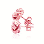 "14k rose gold love knot earrings with high polish ridge motif and ornate textured design"