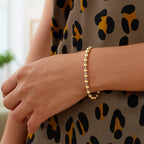 "Elegant 14k two-tone gold chain bracelet with a small diamond-cut bead, 8 inches long and 4mm wide, secured with a pear-shaped lobster clasp."