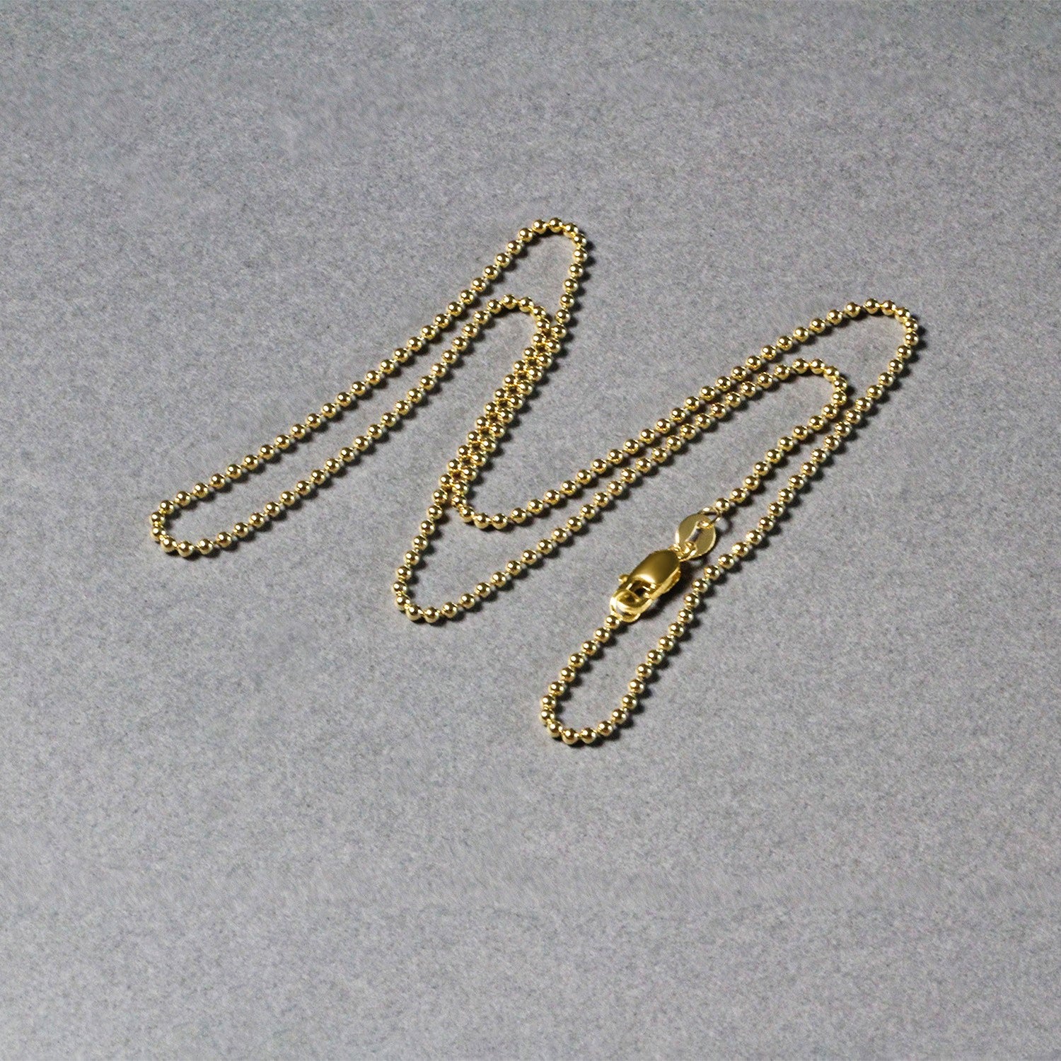 "14k yellow gold non-diamond cut bead chain, 1.5mm in width."