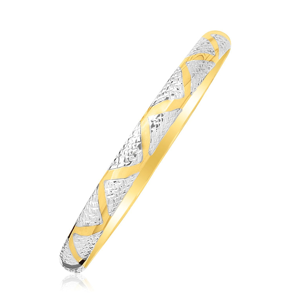 "Elegant 10k yellow and white gold two-tone bangle with polished zigzag sections and textured details, 7 inches"