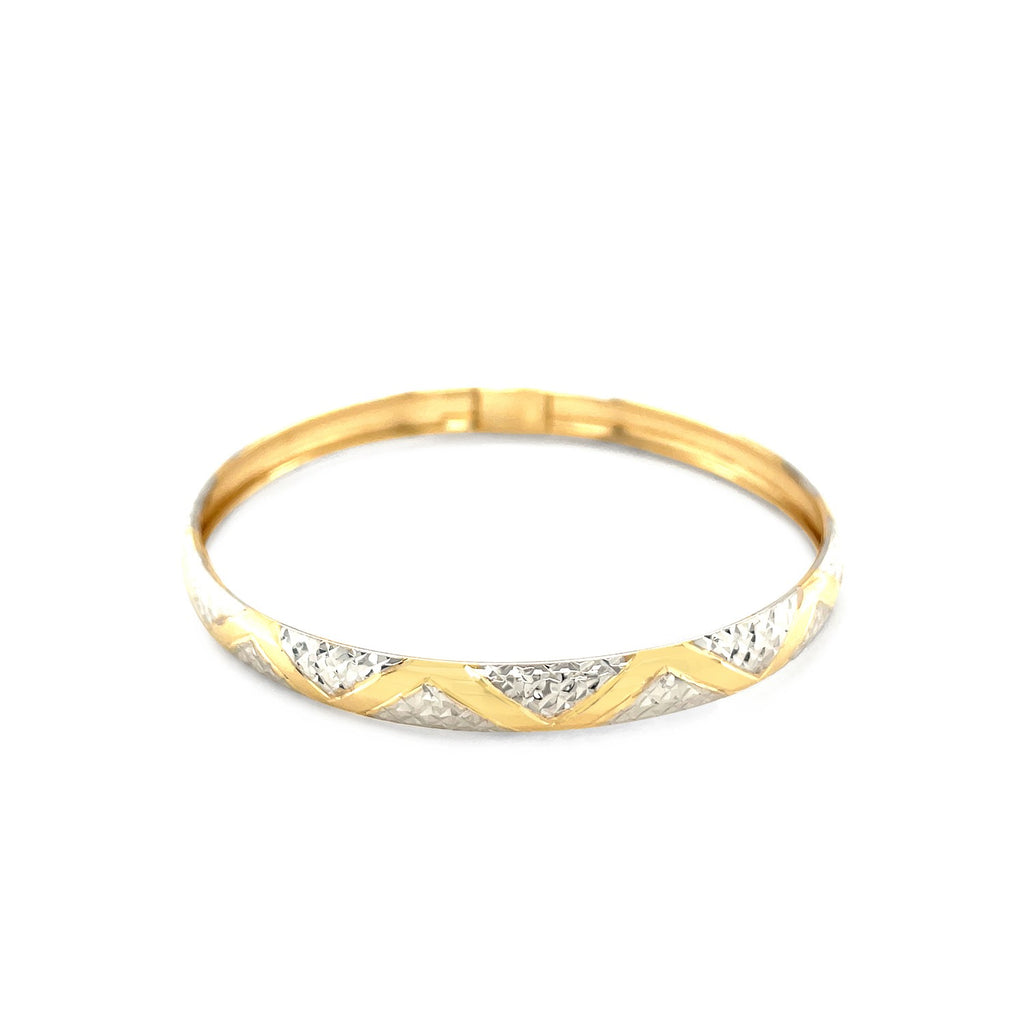 "Elegant 10k yellow and white gold two-tone bangle with polished zigzag sections and textured details, 7 inches"