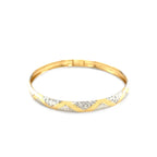"Elegant 10k yellow and white gold two-tone bangle with polished zigzag sections and textured details, 7 inches"