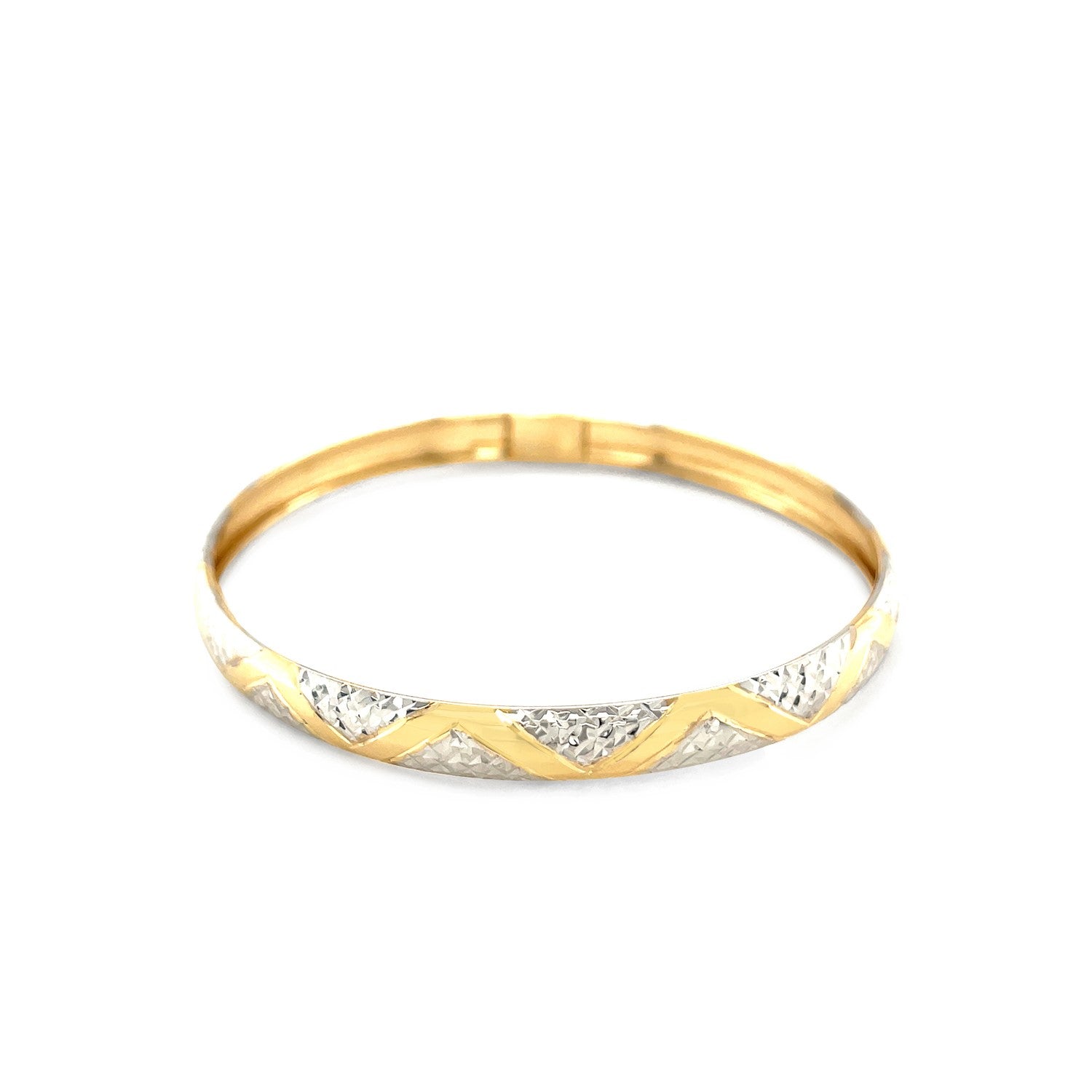 "Elegant 10k yellow and white gold two-tone bangle with polished zigzag sections and textured details, 7 inches"