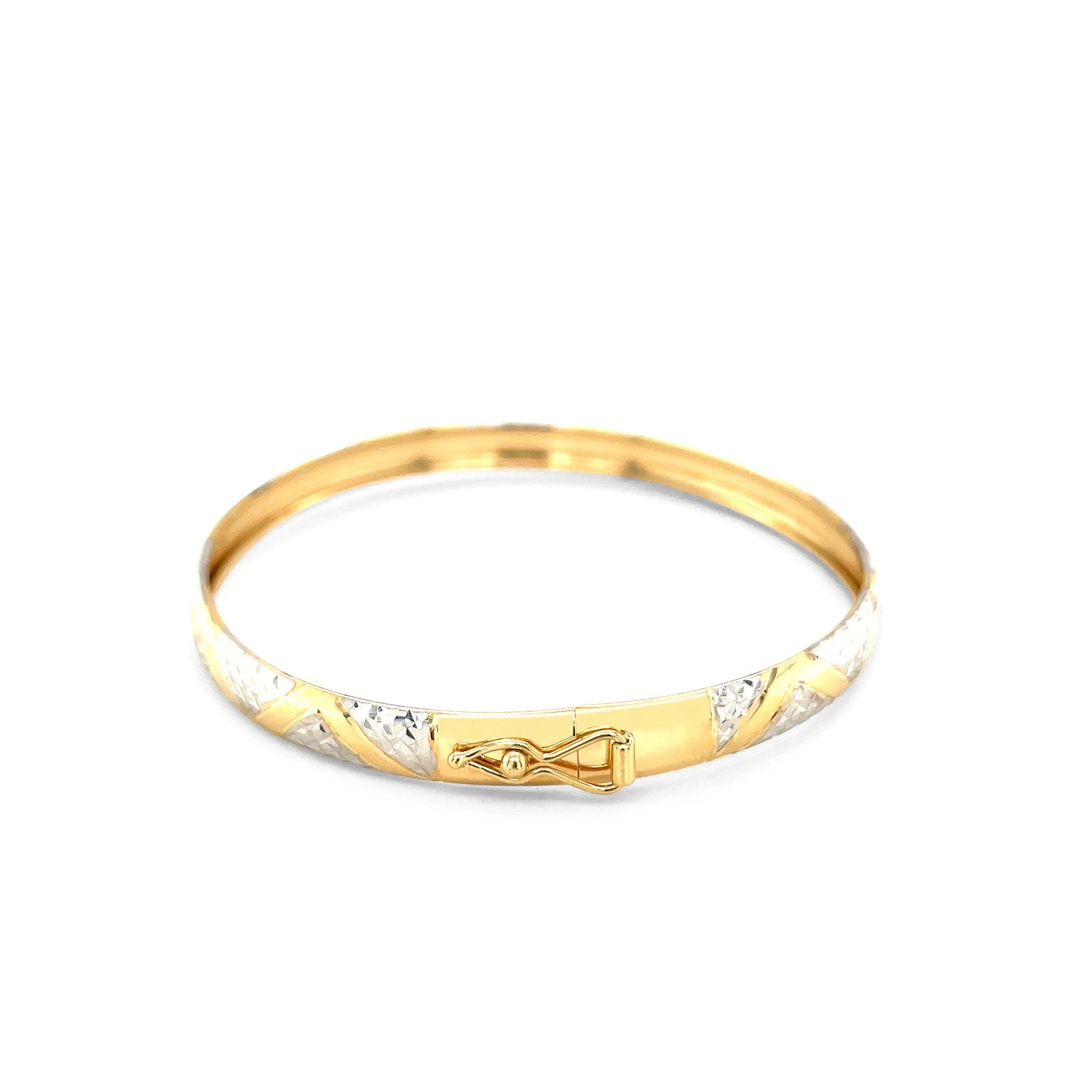"Elegant 10k yellow and white gold two-tone bangle with polished zigzag sections and textured details, 7 inches"