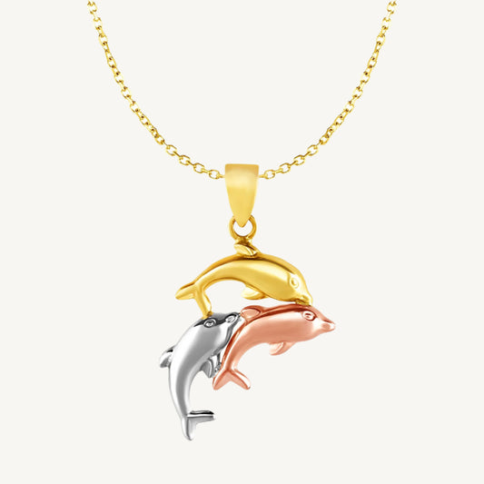 Tri-tone dolphin pendant in yellow, white, and rose gold on an 18-inch chain with lobster clasp.
