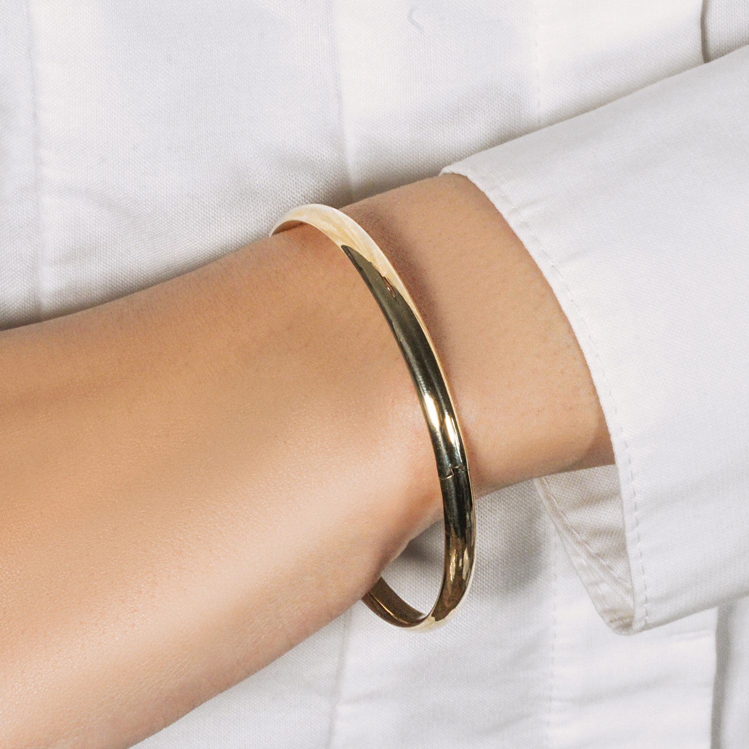 "10k Yellow Gold Dome Style Bangle with polished finish, radiating elegance and simplicity"