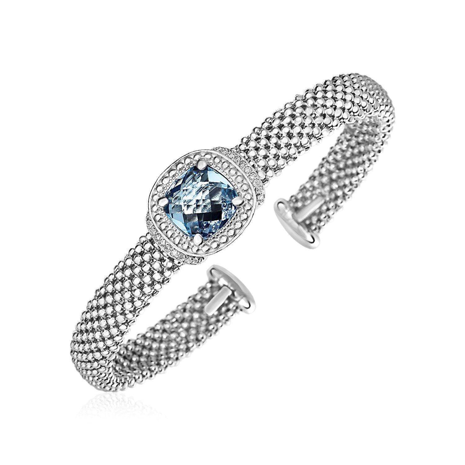 Sterling silver cuff bangle featuring a central blue topaz surrounded by diamonds and textured with a popcorn finish.