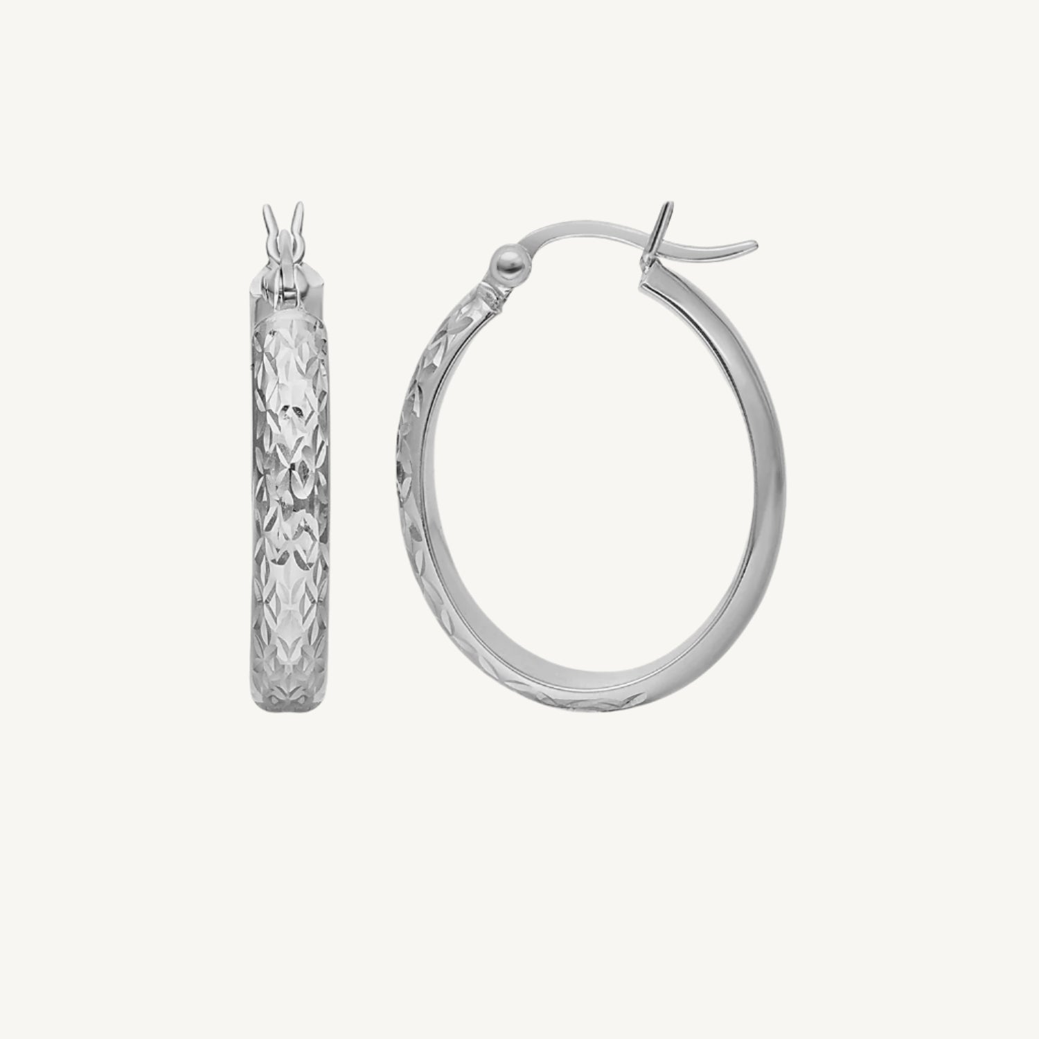 Fine white gold oval hoop earrings with a hammered texture, secured with a snap lock closure for added style and interest.