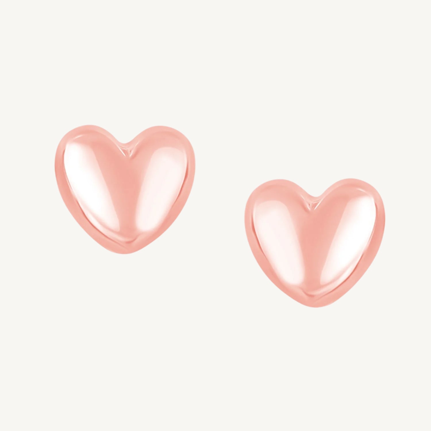 Elegant 14K rose gold earrings with a puffed heart design and a polished finish, secured with push backs.