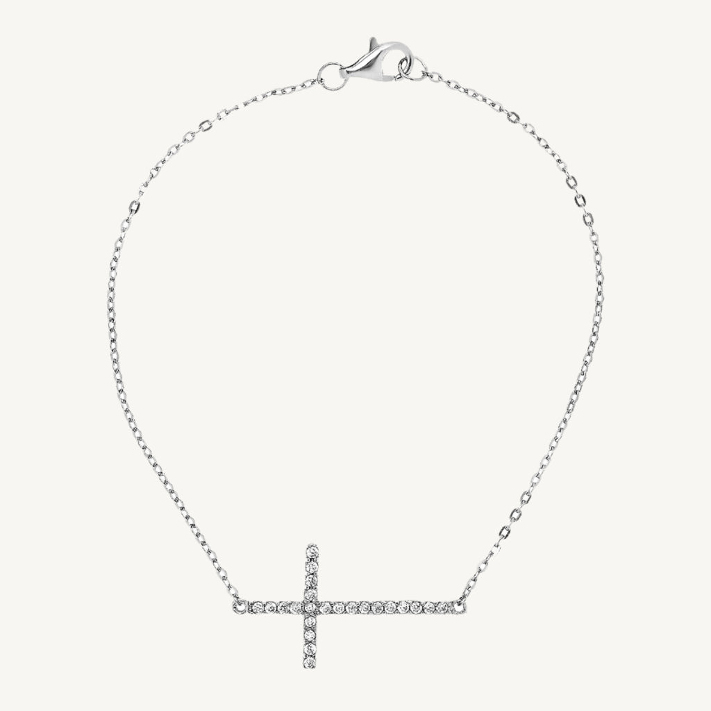 Elegant 7-inch bracelet featuring a classic cross design with sparkling cubic zirconia stones and a lobster clasp closure.