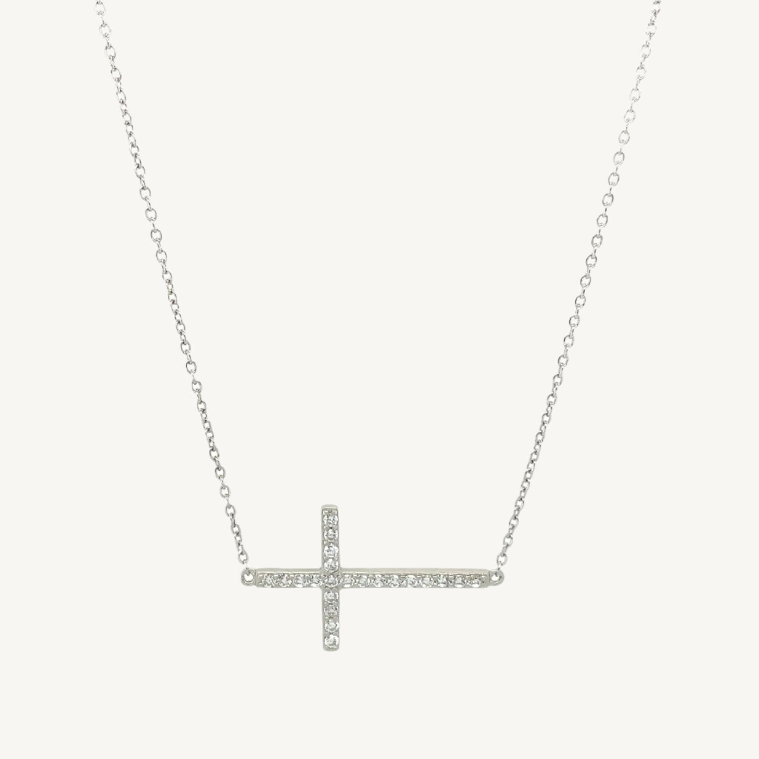 Elegant 7-inch bracelet featuring a classic cross design with sparkling cubic zirconia stones and a lobster clasp closure.