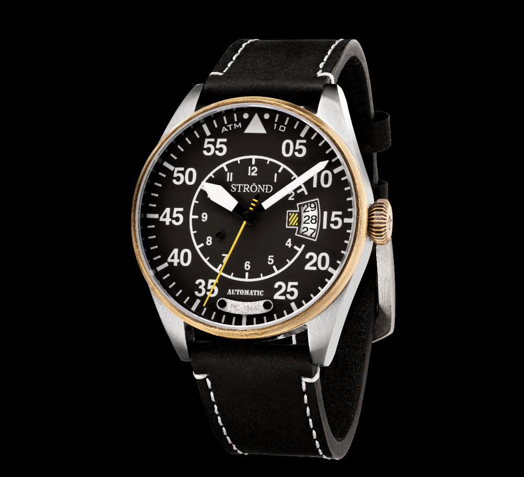 Watch with black dial and leather strap on a white background