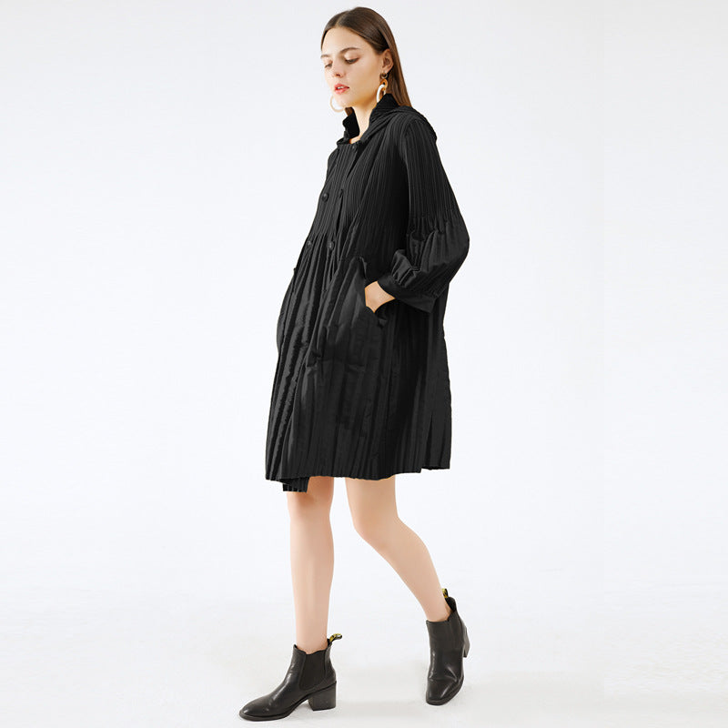 Woman wearing a black dress with long sleeves on a white background