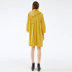 Person wearing a yellow raincoat on a white background