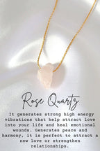 Rose Quartz necklace on a white fabric background with text about its properties.