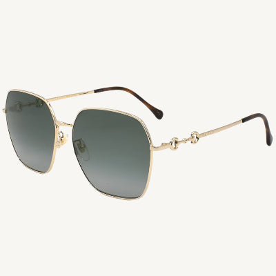 "Gucci women's gold sunglasses, model GG0882SA-001, featuring elegant metal frame with soft curves and luxury Gucci detailing"