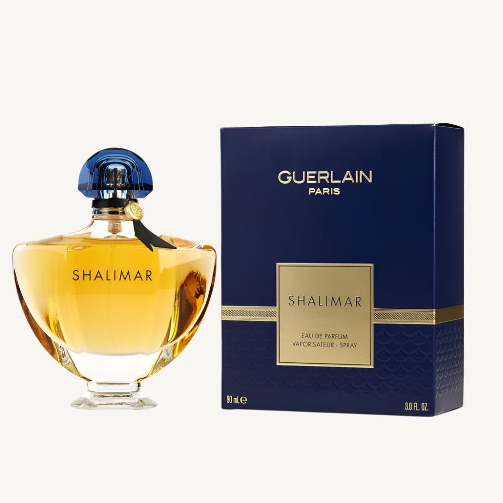 "Guerlain Shalimar 3 oz Eau de Parfum Spray – elegant glass bottle with golden-hued fragrance and iconic fan-shaped blue stopper, presented alongside its classic packaging."​