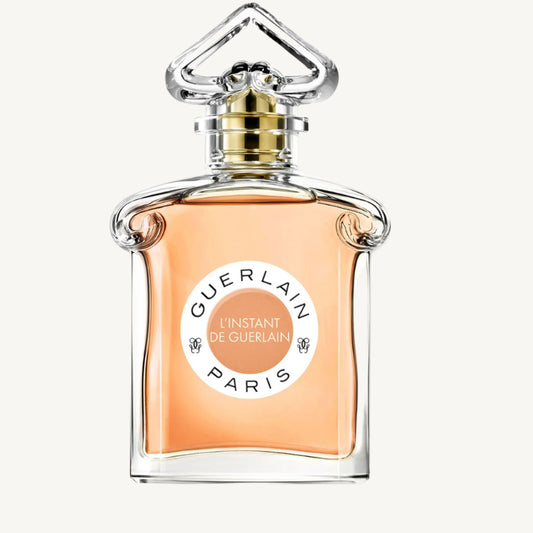 "Guerlain L'Instant de Guerlain 2.5 oz Eau de Parfum Spray for Women – elegant glass bottle with golden-hued fragrance, featuring the iconic inverted heart-shaped stopper, reflecting timeless sophistication."​