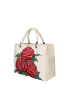 Hand-painted handbag with artwork on both front and back, burgundy cotton logoed interior with three functional pockets, central zip compartment, nickel-colored hardware, rope-colored woven leather handle and matching shoulder strap, secured with double magnetic button closure.