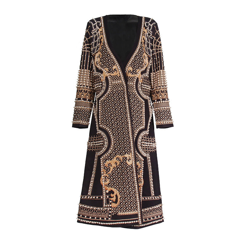 Decorative long-sleeve dress with intricate patterns on a white background