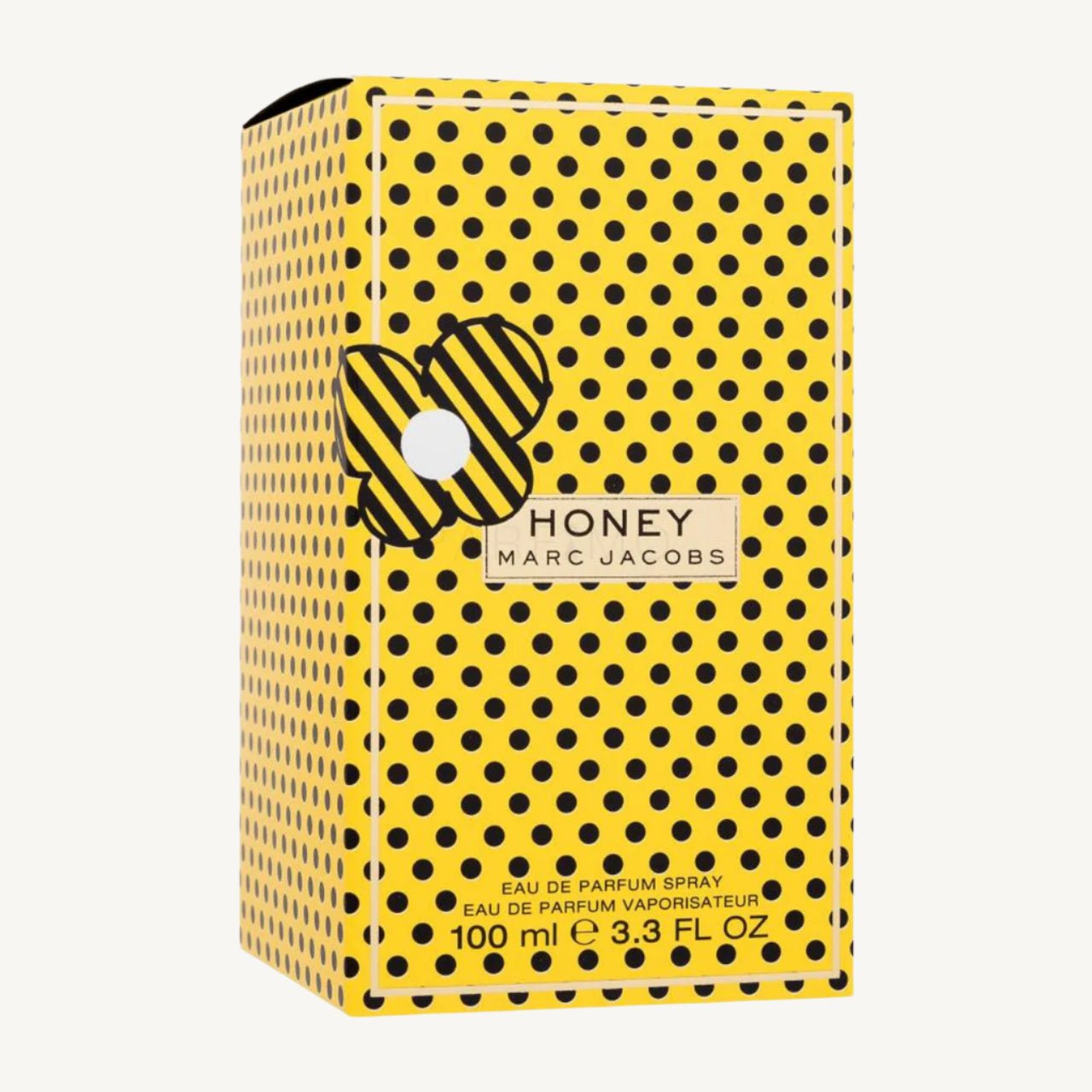 "Marc Jacobs Honey Eau de Parfum 3.3 oz – vibrant yellow bottle adorned with white polka dots and a playful butterfly-shaped cap, presented alongside its matching yellow polka dot box."