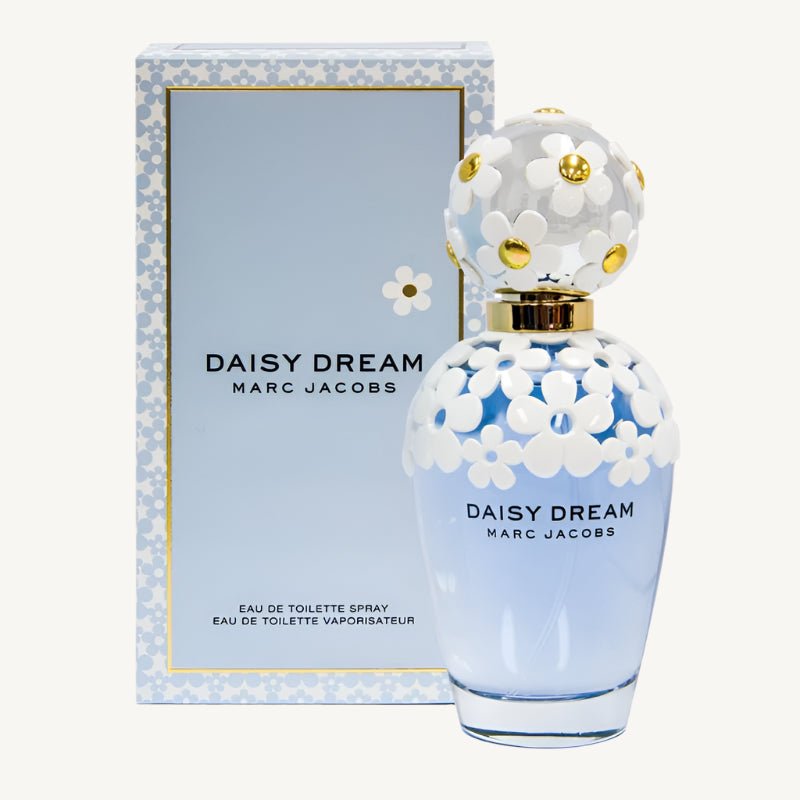 "Marc Jacobs Daisy Dream Eau de Toilette 3.4 oz – a sky-blue glass bottle adorned with delicate white daisies on the cap and shoulders, reflecting a dreamy and feminine design."