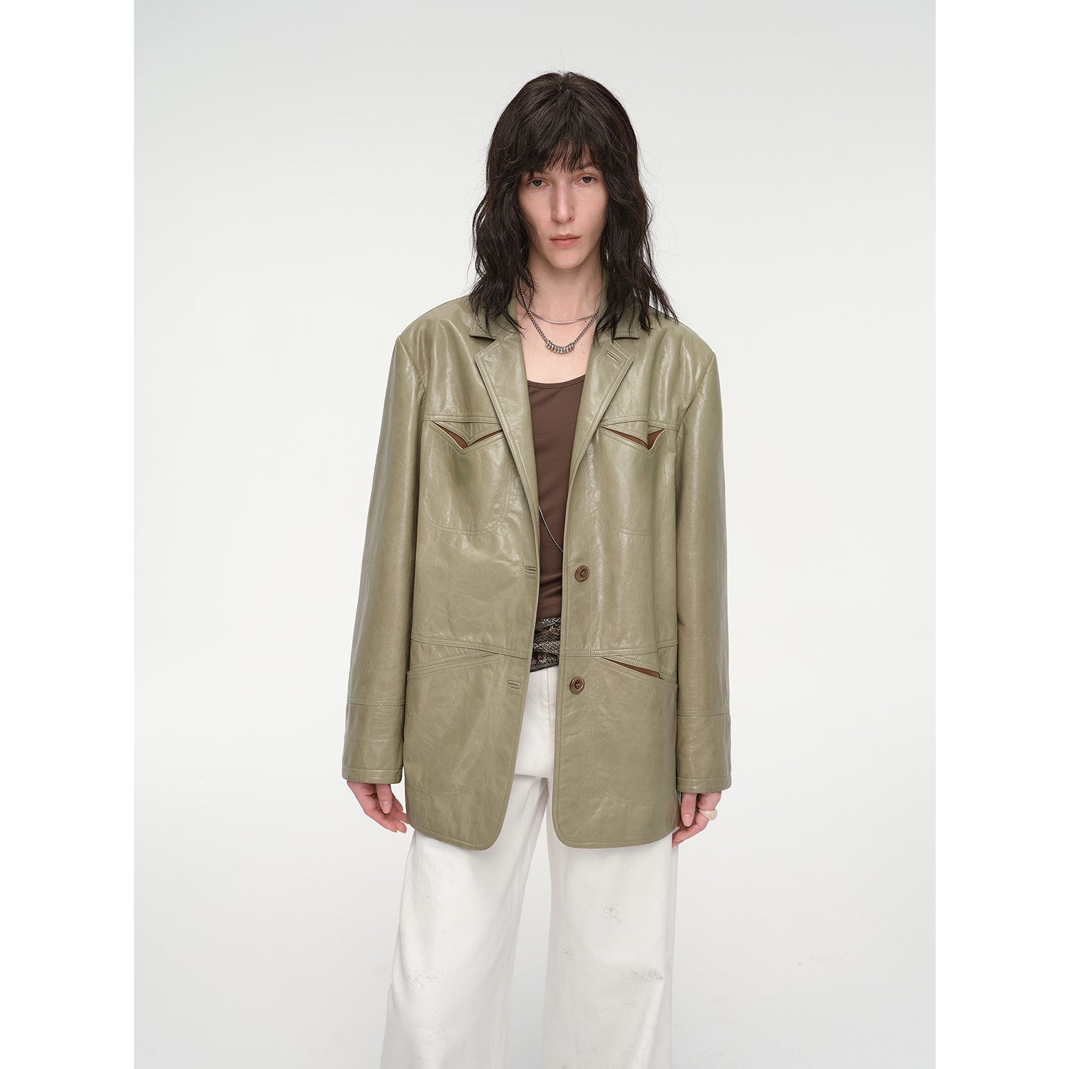 Person wearing a green leather jacket on a white background