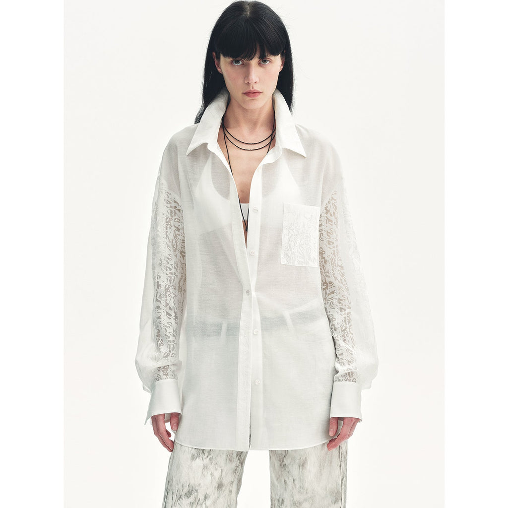 Woman wearing a white blouse with lace sleeves on a white background