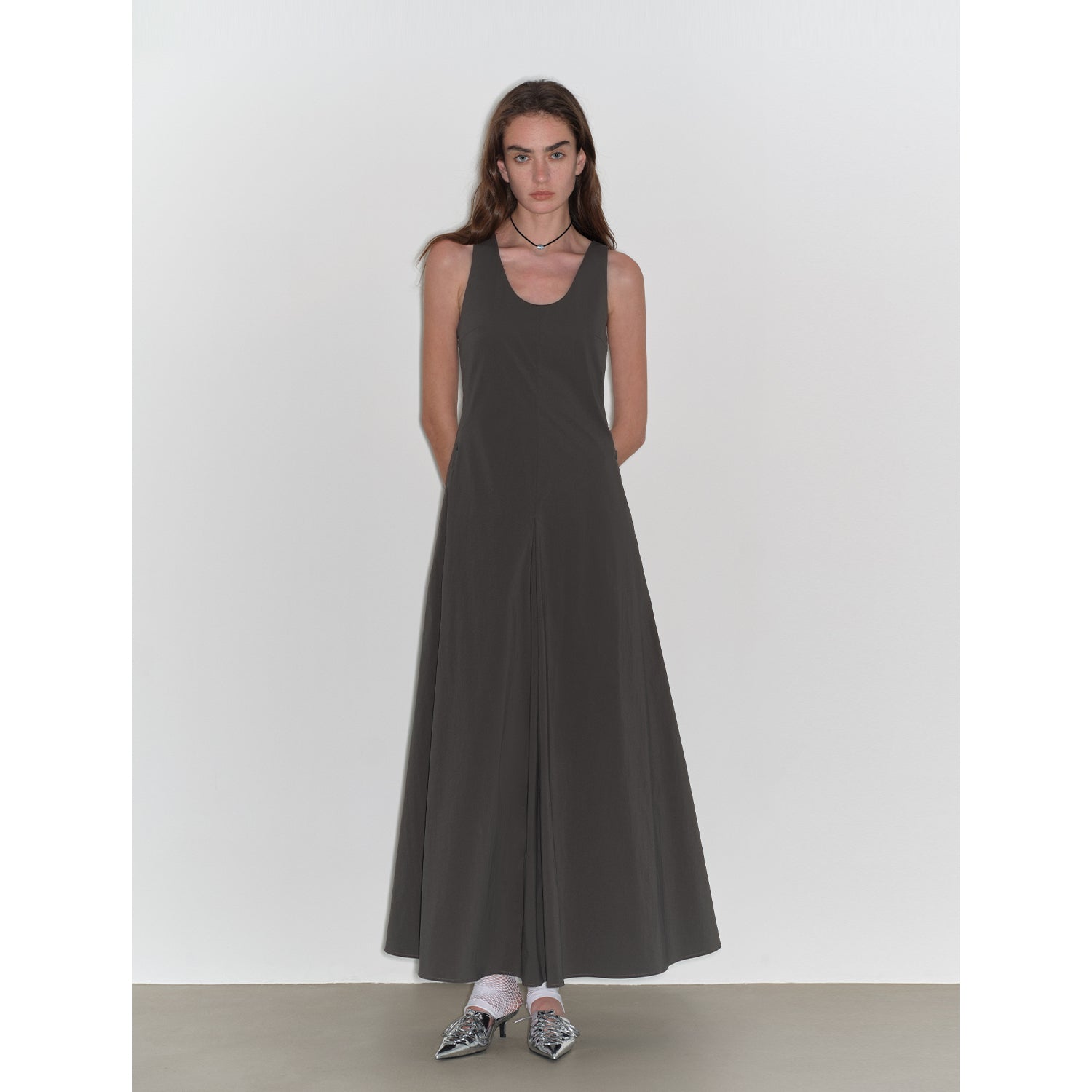 Woman wearing a black sleeveless dress on a white background