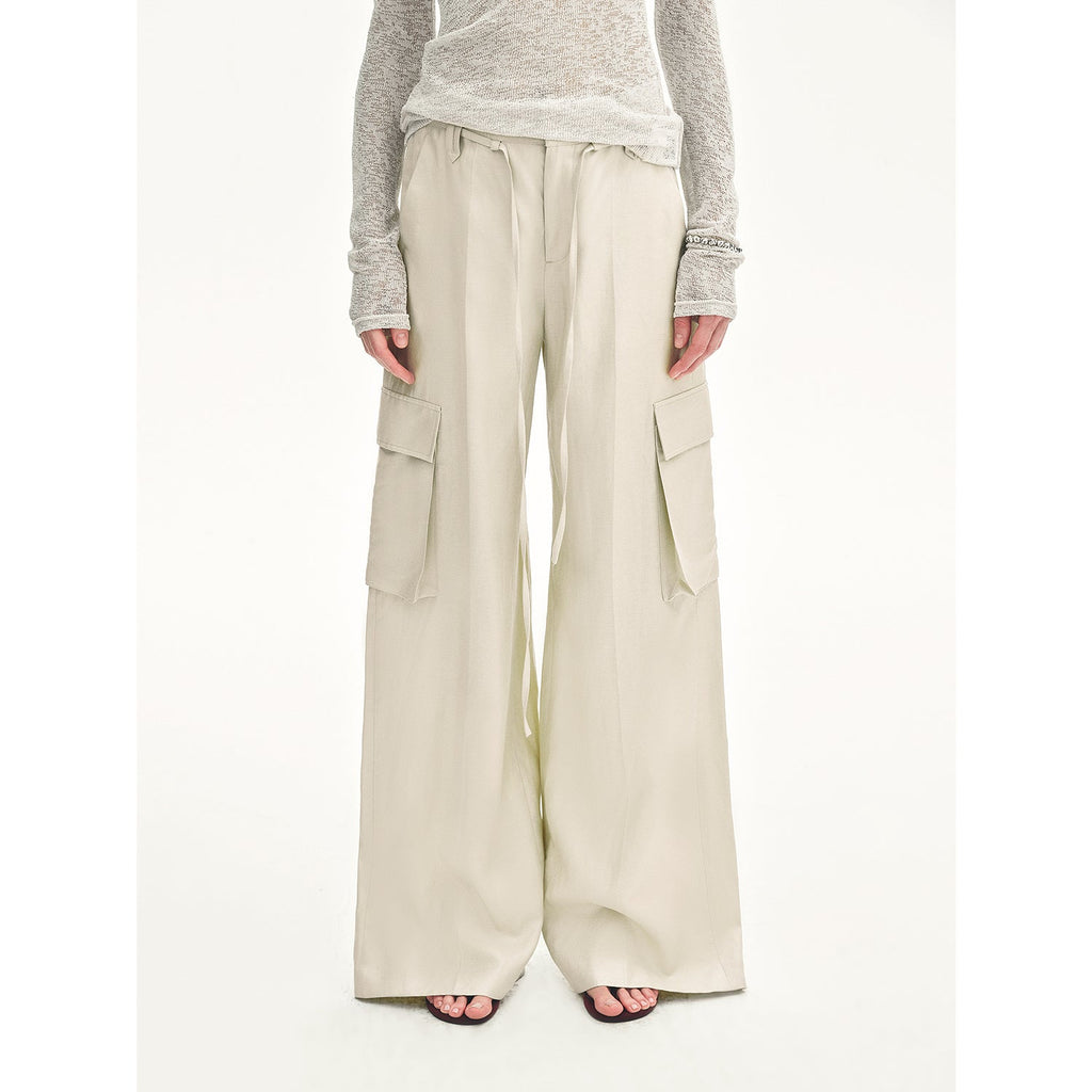 Beige cargo pants worn by a person on a white background