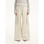 Beige cargo pants worn by a person on a white background