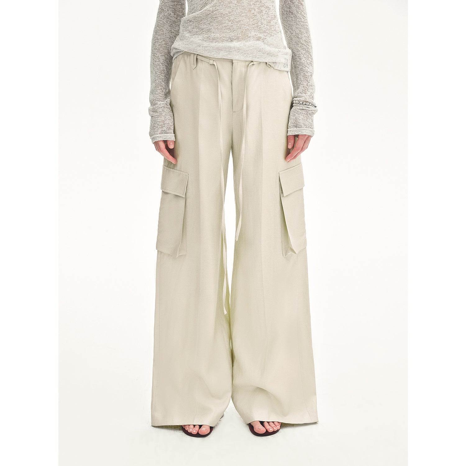 Beige cargo pants worn by a person on a white background